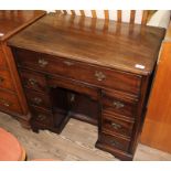 A reproduction mahogany Georgian style knee hole desk, mid 20th century, the top drawer wfitted with