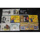 A group of eleven Royal Mint 50p brilliant uncirculated packs including Paddington, Treasures for