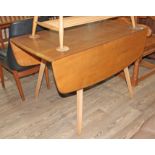 An Ercol light elm and beech drop leaf table.