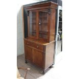 A mahogany secretaire bookcase, second quarter of the 19th century, flared cornice, glazed top