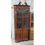 A George III inlaid mahogany corner cabinet, with gilt brass mounted swan neck pediment, astragal