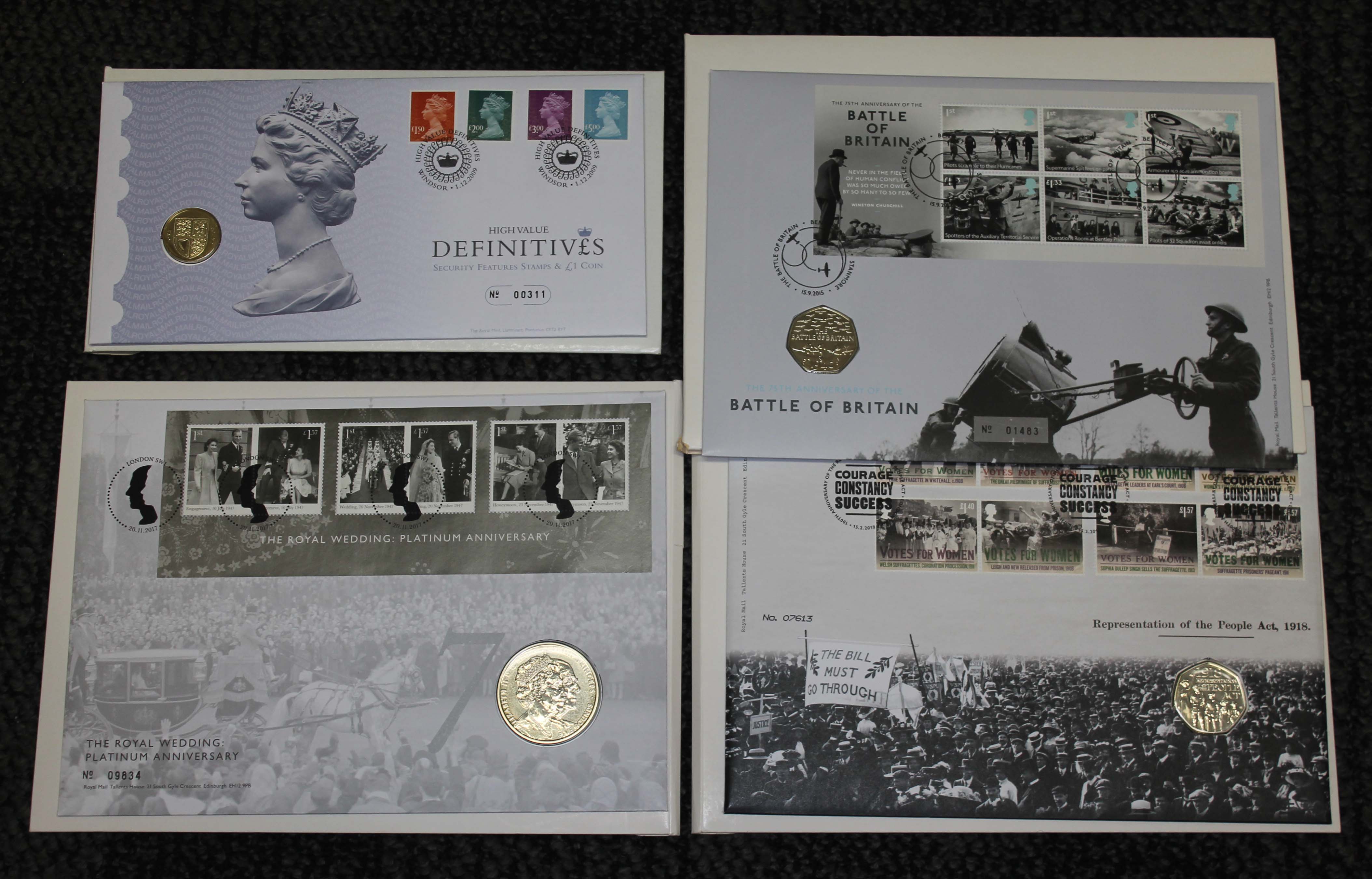 Four coin covers comprising Battle of Britain commemorative 50 pence piece, Votes for Women 50p,