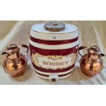 A ceramic whiskey barrel and a pair of Guernsey copper milk cans.