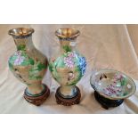 A pair of cloisonne vases on stands and a cloisonne bowl on stand.