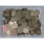 A tub of three pence and various coin sets.