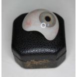 A prosthetic glass eye.