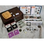 A wooden box with mother of pearl escutcheon and inlaid top containing a quantity of various coins