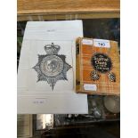 A Wakefield City Police helmet badge and a book 'The Scottish Clans and their Tartans'