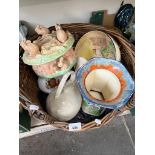 A wicker pet basket containing various items of pottery including Sylvac dish, cat, Royal Doulton,