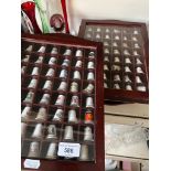 4 glazed display cases with a collection of thimbles