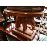 A carved wood elephant table.