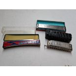 Three vintage harmonicas.