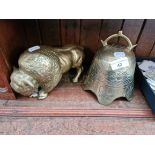 A brass bison and a brass bell.