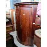 A Georgian inlaid oak and mahogany corner cabinet.