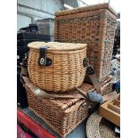 2 wicker picnic baskets with contents and an empty wicker basket.