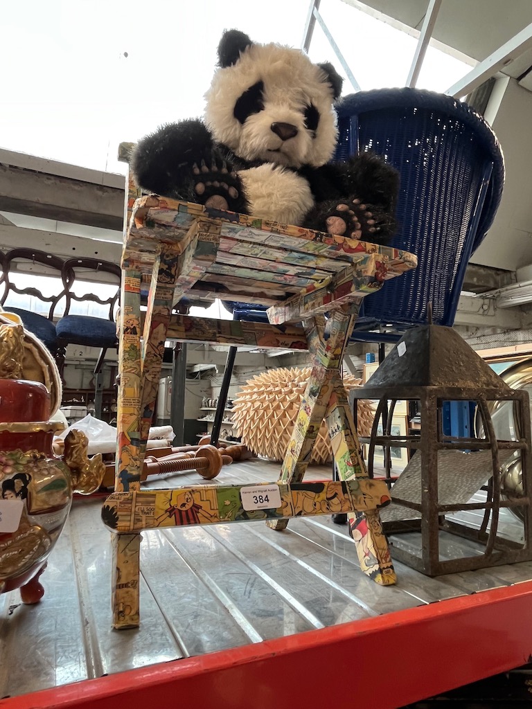 A comic book decoupage children's chair and an electronic toy panda