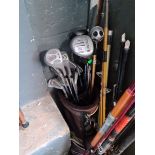 A golf bag with clubs.