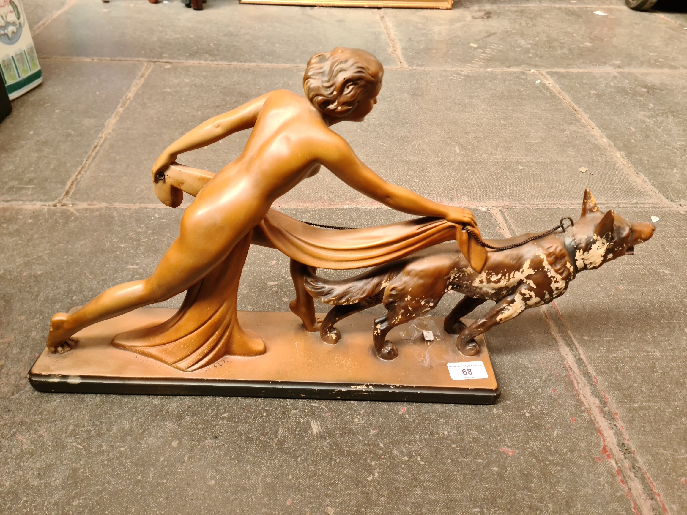 Art Deco group of semi-naked woman with an Alsatian dog, on a rectangular base, bearing impressed