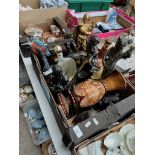 A box of ornaments including brass and spelter figures, cast metal doorstop, Bells whiskey flask,