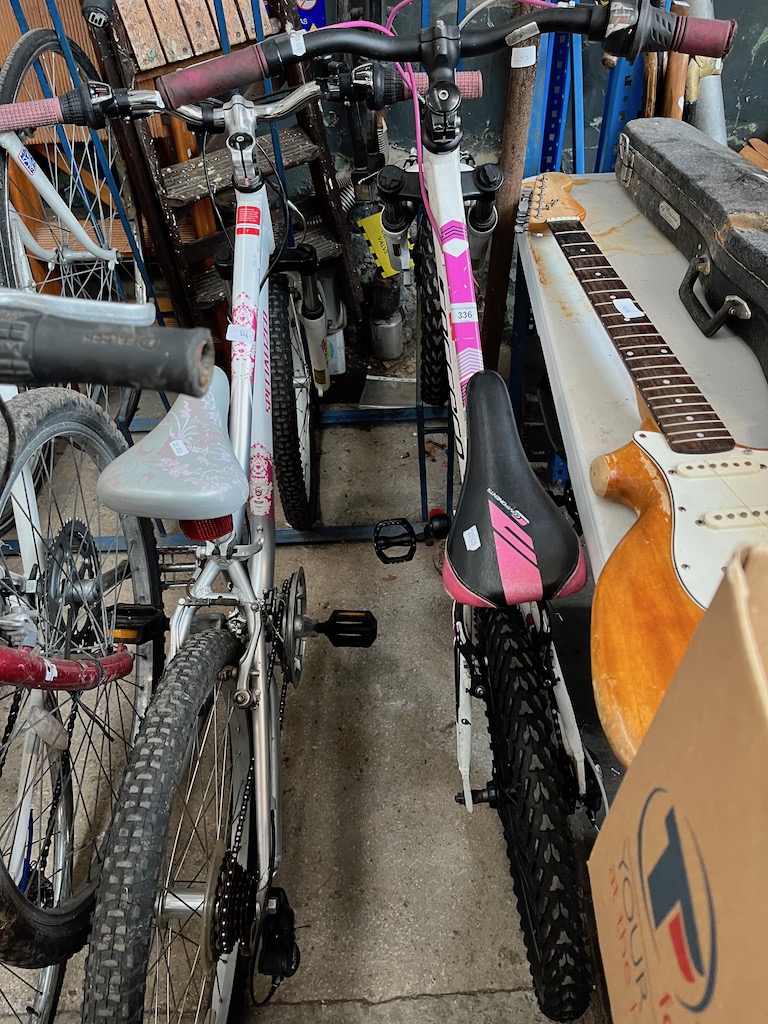 A white and pink Carrera 12" frame bike and a white Specialized 15" frame bike