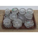 A tray of assorted 19th century pressed glass salts and custard dishes.