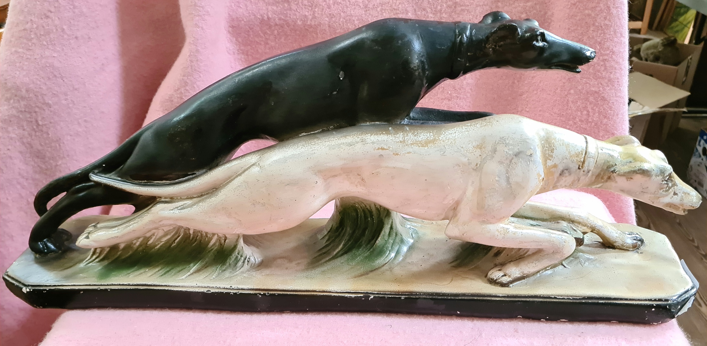 An Art Deco plaster figure modelled as a pair of dogs.