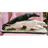 An Art Deco plaster figure modelled as a pair of dogs.