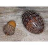 A Victorian hand carved coquilla nut box, 6 cm in length and a carved acorn shaped thimble case with