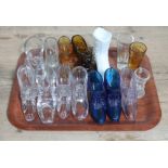 A tray of assorted glass boots and shoes including Sowerby, amber and blue glass.