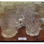 A group of seven pressed glass tankards including one commemorating the opening of the opening of