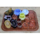 A group of eighteen coloured glass salts/condiments including one amber glass entiteld 'Hush