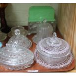 A group of pressed glass butter dishes including two caskets, four lidded examples.