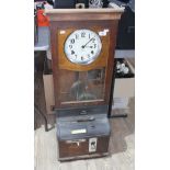 An IBM International oak cased clocking in clock with keys.