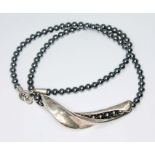 A Danish Modernist silver and hematite bead necklace by Georg Jensen, graduated hemaatite beads with