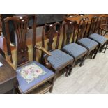 Five Georgian oak dining chairs including one carver.