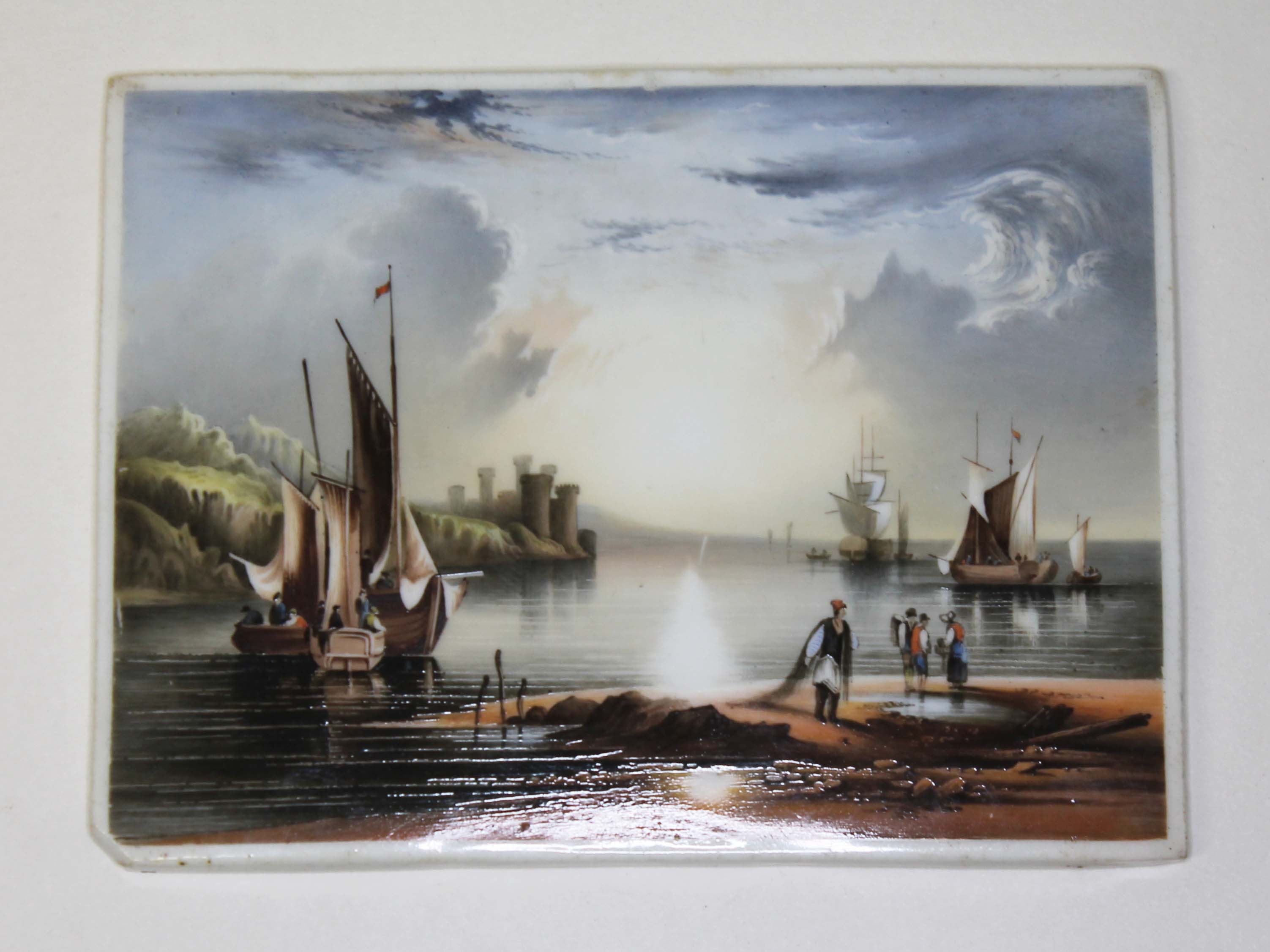 A hand painted porcelain plaque with fishing scene after Arthur Simpson 12cm x 9cm.