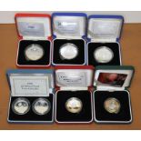 Seven silver proof coins comprising three five pounds and four two pounds, Royal Mint, boxed with