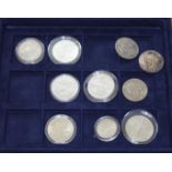 A case of United States coins comprising four commemorative silver proof dollars, an 1884 dollar,