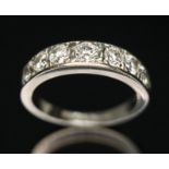 A seven stone diamond half hoop eternity ring, total approx. diamond wt. 1.10 carats, hallmarked