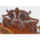 A 19th century Regency period carved mahogany surmount in the form of scrolled acanthus leaves and