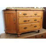 A 19th century pine dresser base, three central drawers flanked either side with curved cupboards,