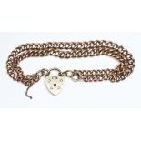 A hallmarked 9ct gold link bracelet with heart shaped clasp, wt. 24.83g.