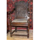 A 17th century oak Wainscot chair, height 118.5cm, width 55cm and depth 53.5cm. The seat, lower legs