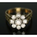 A nine stone diamond cluster ring, the cluster measuring approx. 11.96mm in diameter, engraved