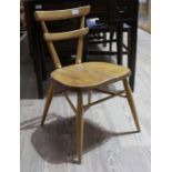 A vintage Ercol light beech and elm child's stacking chair with red dot to the back, height 64.