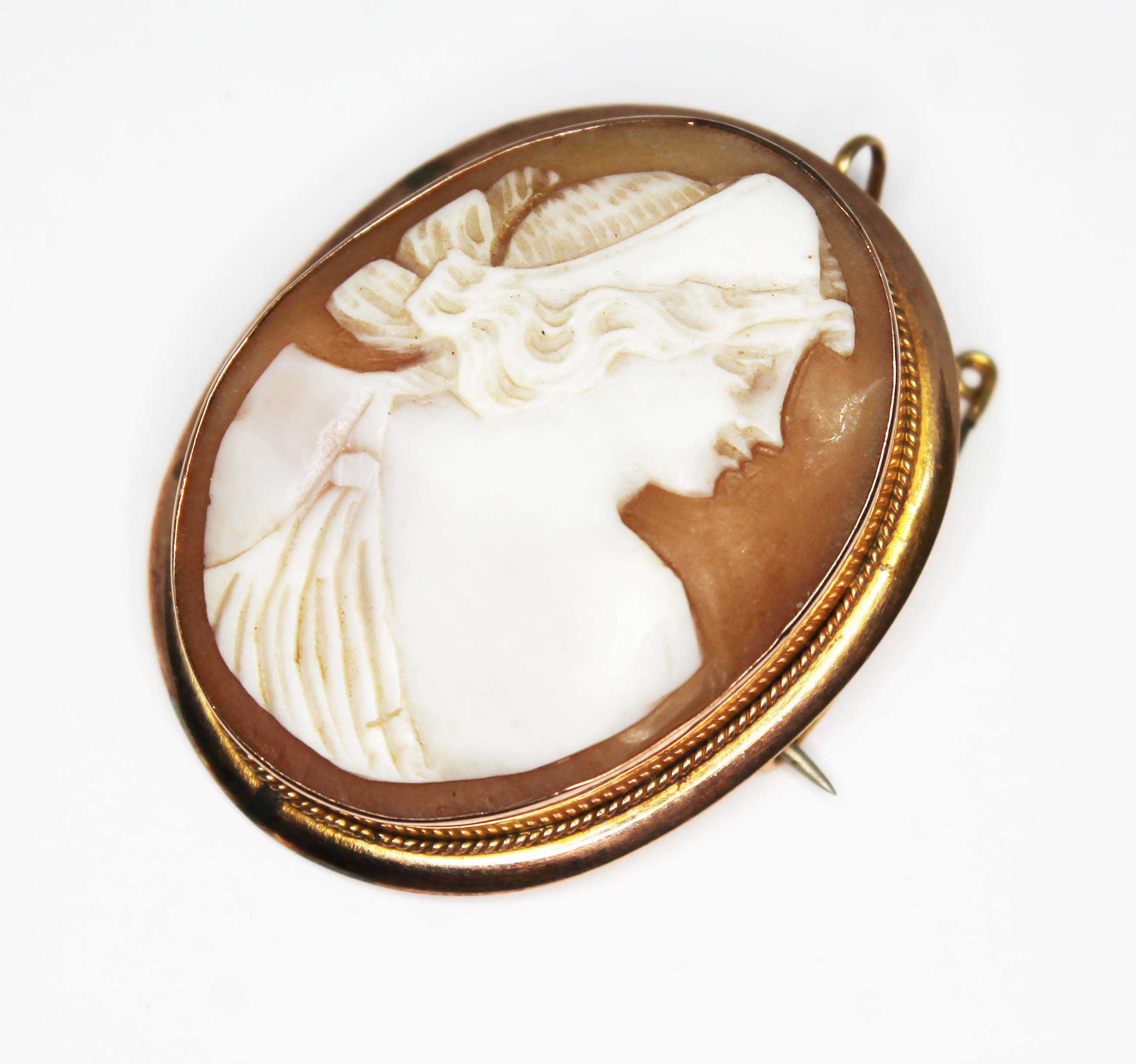 A yellow metal mounted shell cameo brooch, marked '9ct', gross wt. 7.86g, length 40mm.