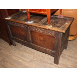 An 18th century oak coffer with carved details to the front, height 70cm, width 124.5cm and depth