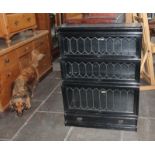 An early 20th century leaded glass and ebonised sectional bookcase, width 87cm, depth 30cm &