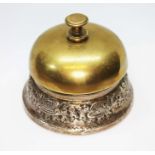 A white metal mounted brass desk bell, unmarked, diameter 8cm.