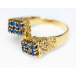 A Brutalist style ring set with blue stones, indistinctly marked, gross wt. 6.30g, size Q. Condition